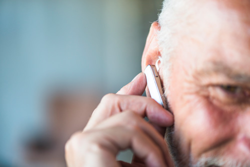Ear and Eye Health - Senior putting in hearing aid