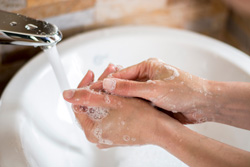Person washing hands to prevent sickness